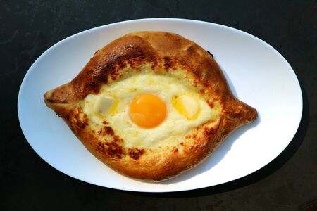 Adjarian Khachapuri, Cheese and Fresh Egg Filled Traditional Georgian Breadの写真素材