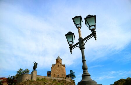 Vintage street lamp post with Metekhi church in the backdrop, Tbilisi, Georgia