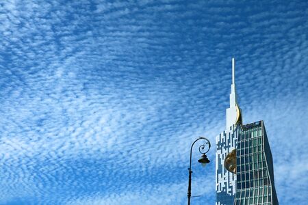 Modern Skyscraper and the Streetlamp against Sunny Blue Sky with Cirrocumulus Clouds, Batumi,...