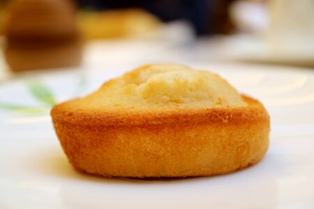 Closeup a Financier, French Almond Petit-Four Cake Served on White Plateの写真素材