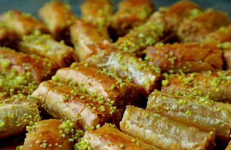 Closeup Heap of Baklava Pastries Topped with Chopped Pistachio Nutsの写真素材