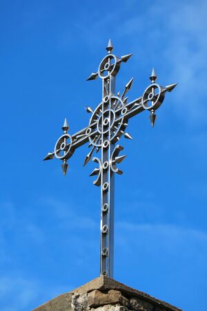 Decorative Cross of a Georgian Orthodox Church on Vivid Blue Skyの写真素材