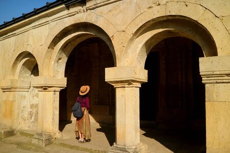 Female visitor at the entrance of a St. George church in Gerati Monasteric Complex, Kutaisi, Georgia