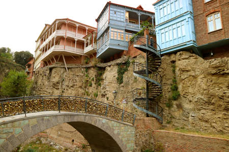 Bridge of Lovers Filled with Padlocks and Group of Georgian Traditional Buildings in the Backdrop, Old Tbilisi, Georgiaのeditorial素材
