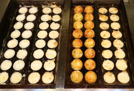 Japanese Takoyaki Octopus Balls Being Grilled in the Molded Panの写真素材