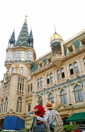 Couple Admiring the Astronomical Clock Tower of Batumi, a Remarkable Landmark on Europe Square in Batumi City, Adjara Region, Georgiaの写真素材