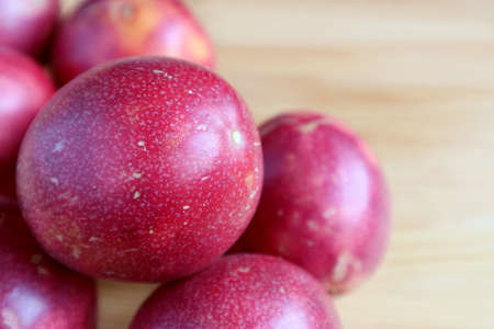 Closeup a Fresh Ripe Passion Fruit on the Pile on Wooden Table