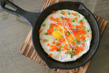 Top view of fried eggs topped with salmon roe, shrimp roe and microgreen for breakfastの写真素材