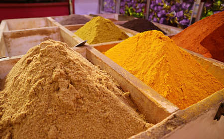 Vivid yellow and brown spices in the traditional market (Souq) in Manama, the capital city of...