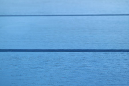 Closeup vivid blue colored horizontal pattern of wooden table surfaceの写真素材