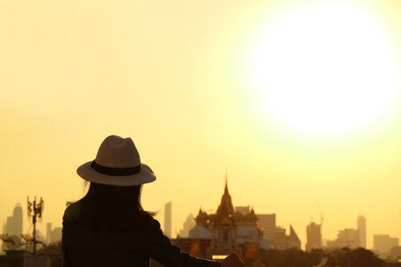 Woman in Hat Enjoy an Amazing View of Bangkok Skyline with the Popular Landmarks, Thailandの写真素材