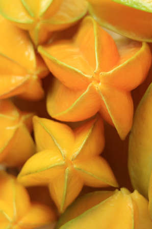 Vertical Image of Pile of Fresh Ripe Star Fruits or Carambola for Background or Wallpaperの写真素材