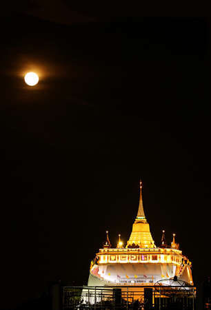 Fantastic View of Light-up Phu Khao Thong Stupa or Golden Mount of Wat Saket Temple on the Full Moon Night, Bangkok Old City, Thailandの写真素材