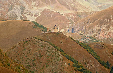 Gergeti Trinity Church or Tsminda Sameba on the Hilltop with Mount Kazbek in the Backdrop,...