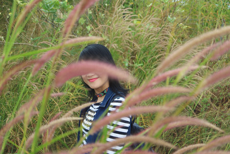 One Happy Hiker Smiling in a Beautiful Pennisetum Fieldの写真素材