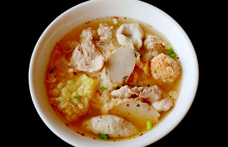 Closeup a Bowl of Thai Rice Noodles Soup with Assorted Fish Balls and Pork