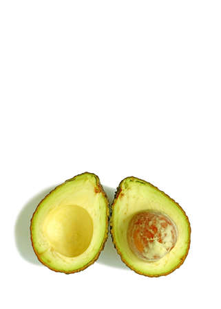 Cut in half fresh ripe avocado isolated on white backgroundの写真素材