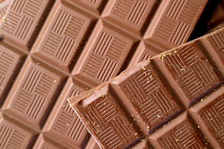 Closeup heap of cracked chocolate bar with selective focus