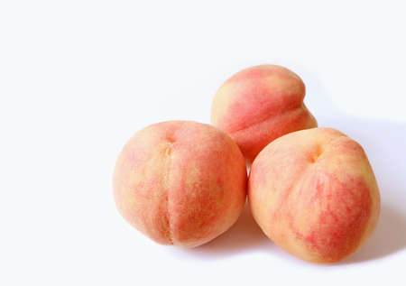 Three of Fresh Ripe Peaches Isolated on White Backdropの写真素材