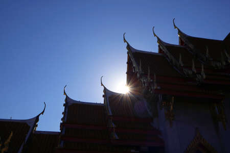 Bright Sunbeam Shining Through the Gable Roofs of Wat Benchamabophit or The Marble Temple in Bangkok, Thailandの写真素材
