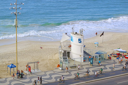 Aerial view of group of people cycling on the cycle lane along Copacabana beach in Rio de Janeiro, Brazilのeditorial素材