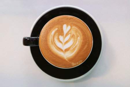 Top view of mouthwatering frothy cappuccino coffee with beautiful latte artの写真素材