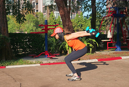 Woman Doing Weight Training in the Morning Sunlight