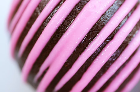 Closeup of Artistic Detail of Chocolate Cake Truffle Coated with Strawberry Icing