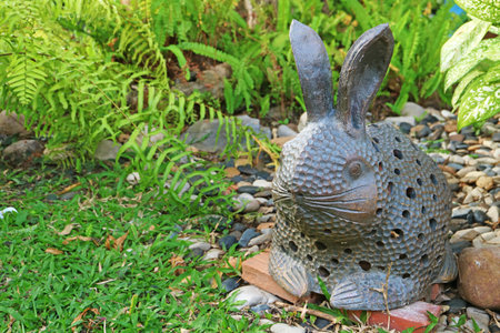 Artistic Easter Bunny Stone Figurine in the Gardenの写真素材