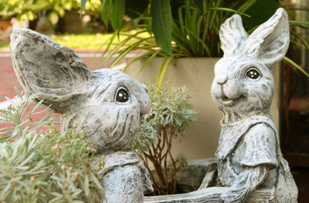 Pair of Adorable Easter Bunny Sculptures at the Yardの写真素材