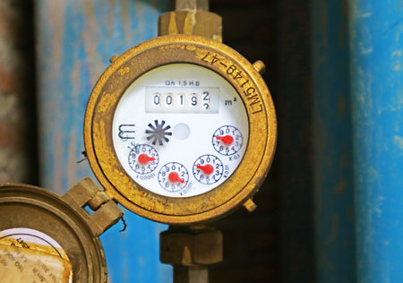 Weathered velocity water meter with pipes in the backdropの写真素材