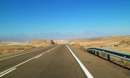 Empty Road with a Signpost in the Arid Desert of Atacama Desert, Antofagasta Region, Northern Chile, South Americaの写真素材