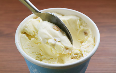 Closeup of spoon scooping delectable rum raisin ice creamの写真素材