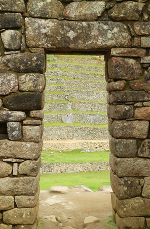 Ancient doorway with the remains of the Inca Ruins in Machu Picchu Citadel, a New Seven Wonder of the World Site in Cusco Region, Peru, South Americaのeditorial素材