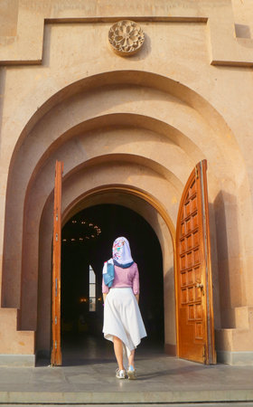 Female in White Headdress Entering Yerevan Cathedral, Located in the Central District of Yerevan,...