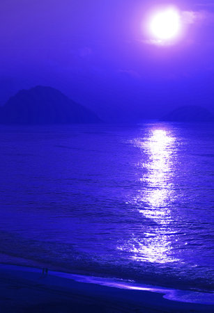 Pop art surreal style of bright sun rising on the sea in ultramarine blue colorの写真素材