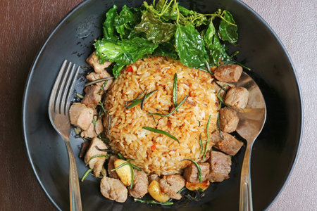 Delectable Garlic Fried Rice with Rosemary Grilled Beef and Deep Fried Crispy Holy Basilの写真素材