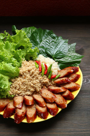 Delectable Sai Krok-Planaem, Thai Style Grilled Spicy Pork Sausages with Shredded Fish and Pork Saladの写真素材