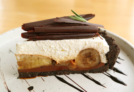Closeup of a Slice of Mouthwatering Banoffee Pie on White Plate