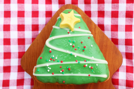Delectable Christmas Tree Shaped Doughnut on Checkers Table Clothの写真素材