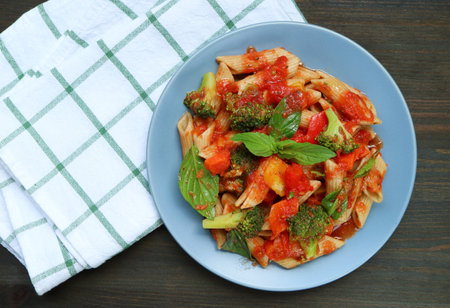 Plate of Freshly Cooked Penne Pasta in Marinara Sauce on Kitchen Tableの写真素材