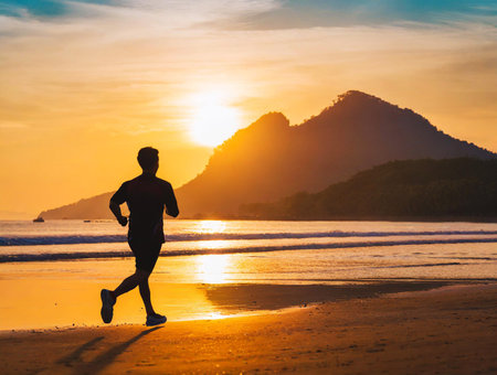 Silhouette of a man jogging on the morning  beachの素材