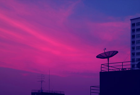 Pop Art of Vibrant Blue and Purple Tone Satellite Dish on the High Building Against Evening Sky