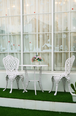 White Colored Wrought Iron Tea Table and Chairs in the Backyardの写真素材