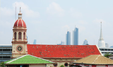 Santa Cruz Church, a Well Known Historical Roman Catholic Church in Kudi Chin Neighborhood with Bangkok Skyline, Thailandの写真素材