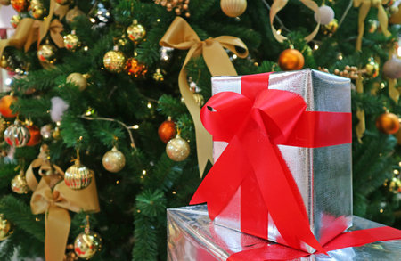 Christmas Decorations with Christmas Tree Filled with Ornament and Stack of Gift Boxes