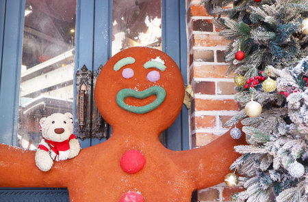 Huge gingerbread man figure and adorable polar bear soft toy with Christmas tree