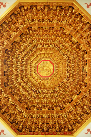 Incredible Golden Chinese Phoenix Wood Carving on the Ceiling of a Chinese Buddhist Templeのeditorial素材