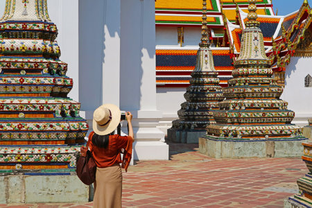 Female Visitor at The Courtyard of Temple of Reclining Buddha or Wat Pho, Located in Rattanakosin Island, Bangkok, Thailandの写真素材