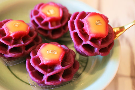 Delectable Sweet and Tangy Flower Shaped Modern Thai Dessert Made of Purple Sweet Potato and Mango Curdの写真素材